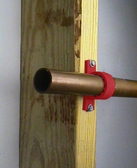 A pipe clamp attached to a wood stud with a copper tube running through it.  Click on photo to download a link about Pipe Clamps.
